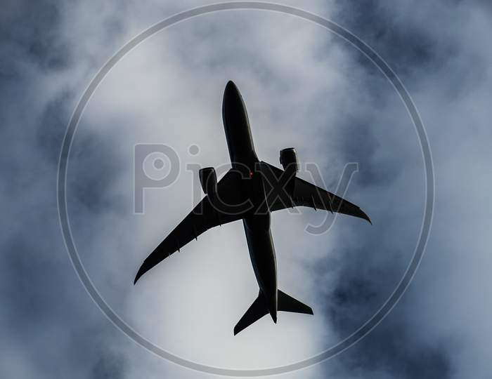 Cloudy Sky And Airliner Silhouette