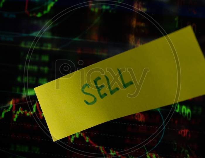 Concept Of Sell Written On Sticky Notes Attached On Share Market Graph.