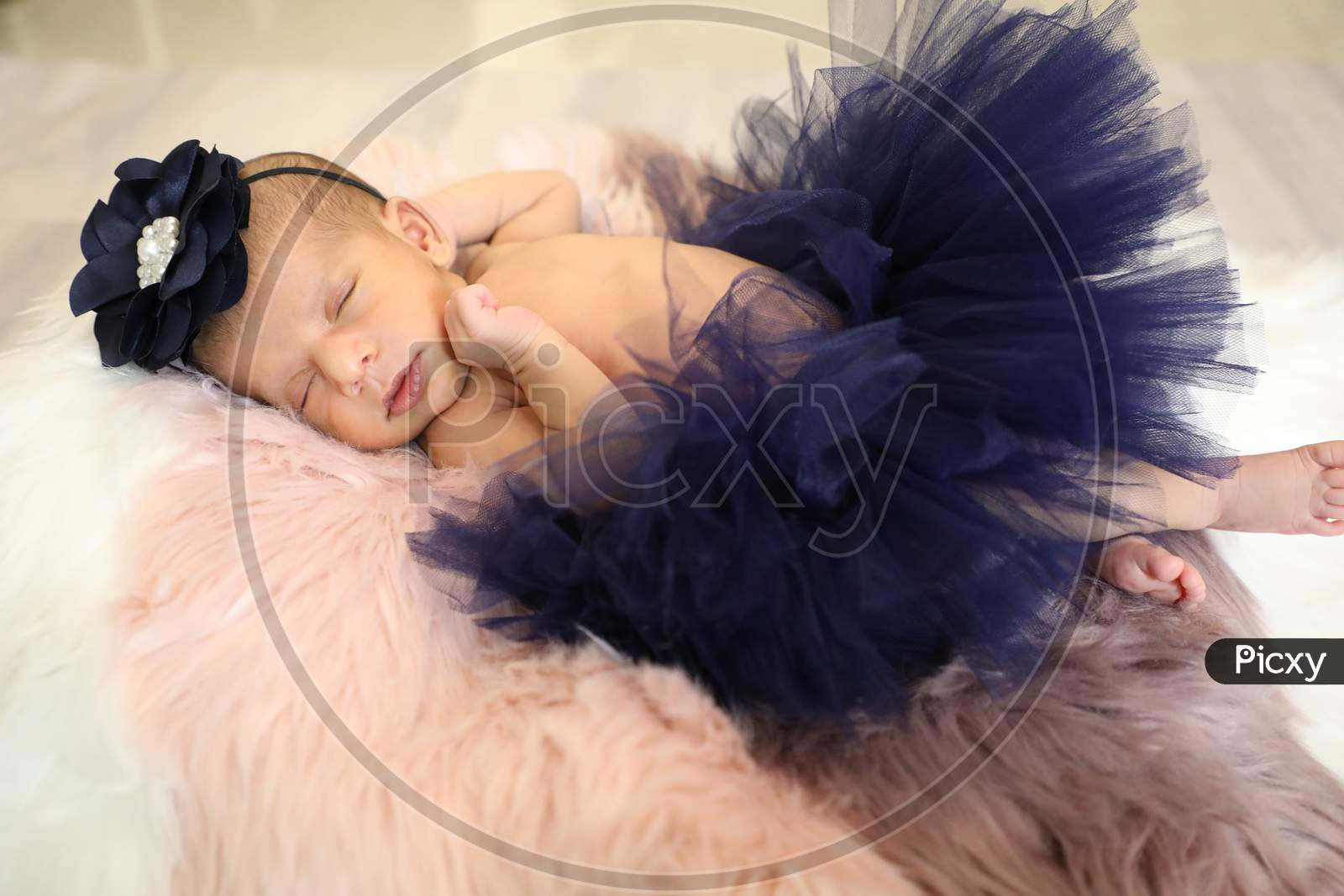 Little Pretty Girl With Beautiful Blue Frock Sleeping On Soft Wool