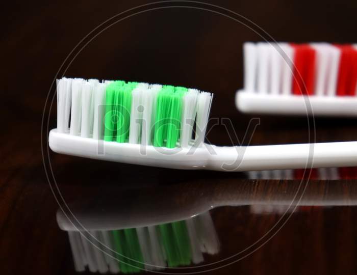 Tooth Brush On A Glossy Object,Reflexion,White And Green Tooth Brush