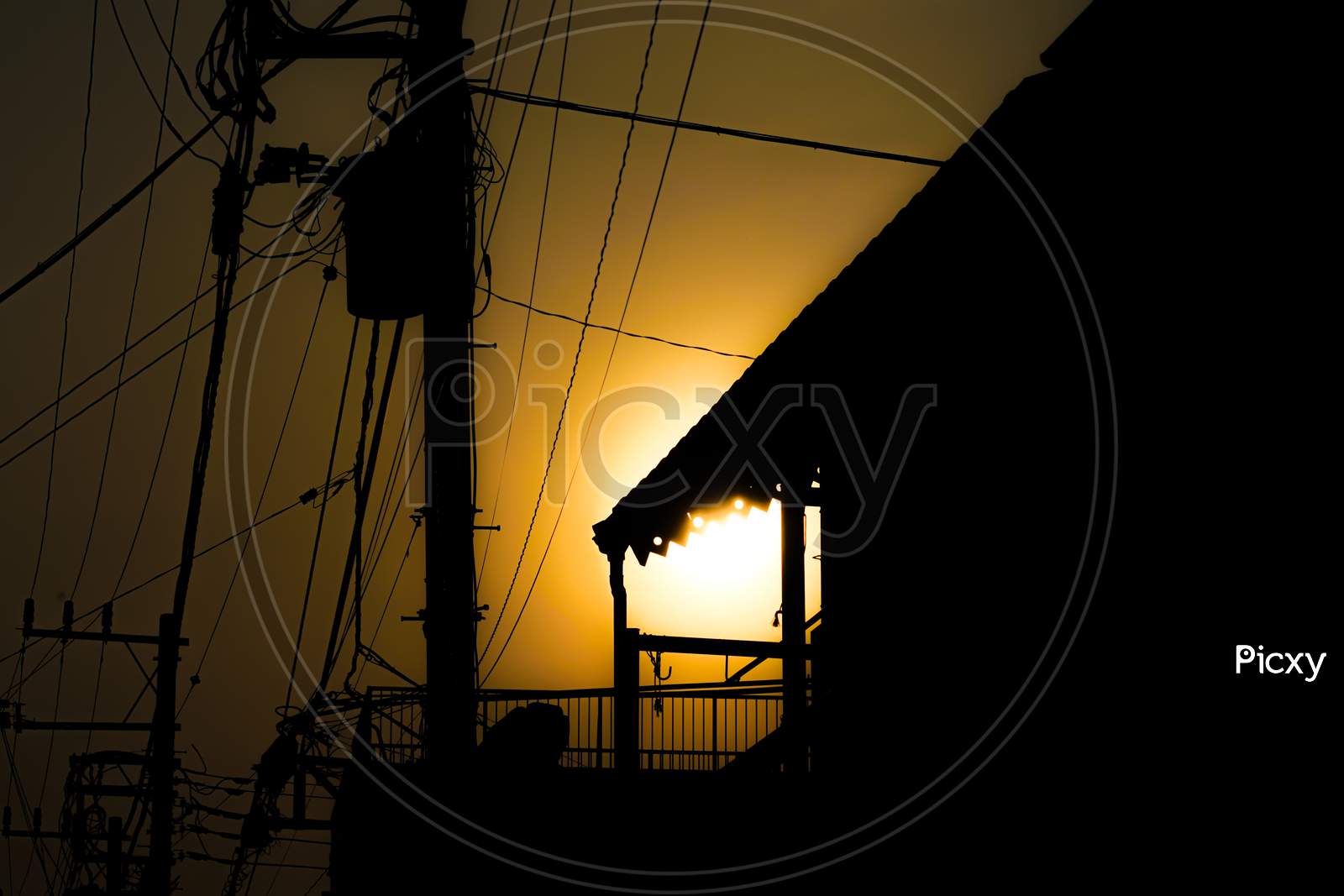 Utility Poles And House Silhouette