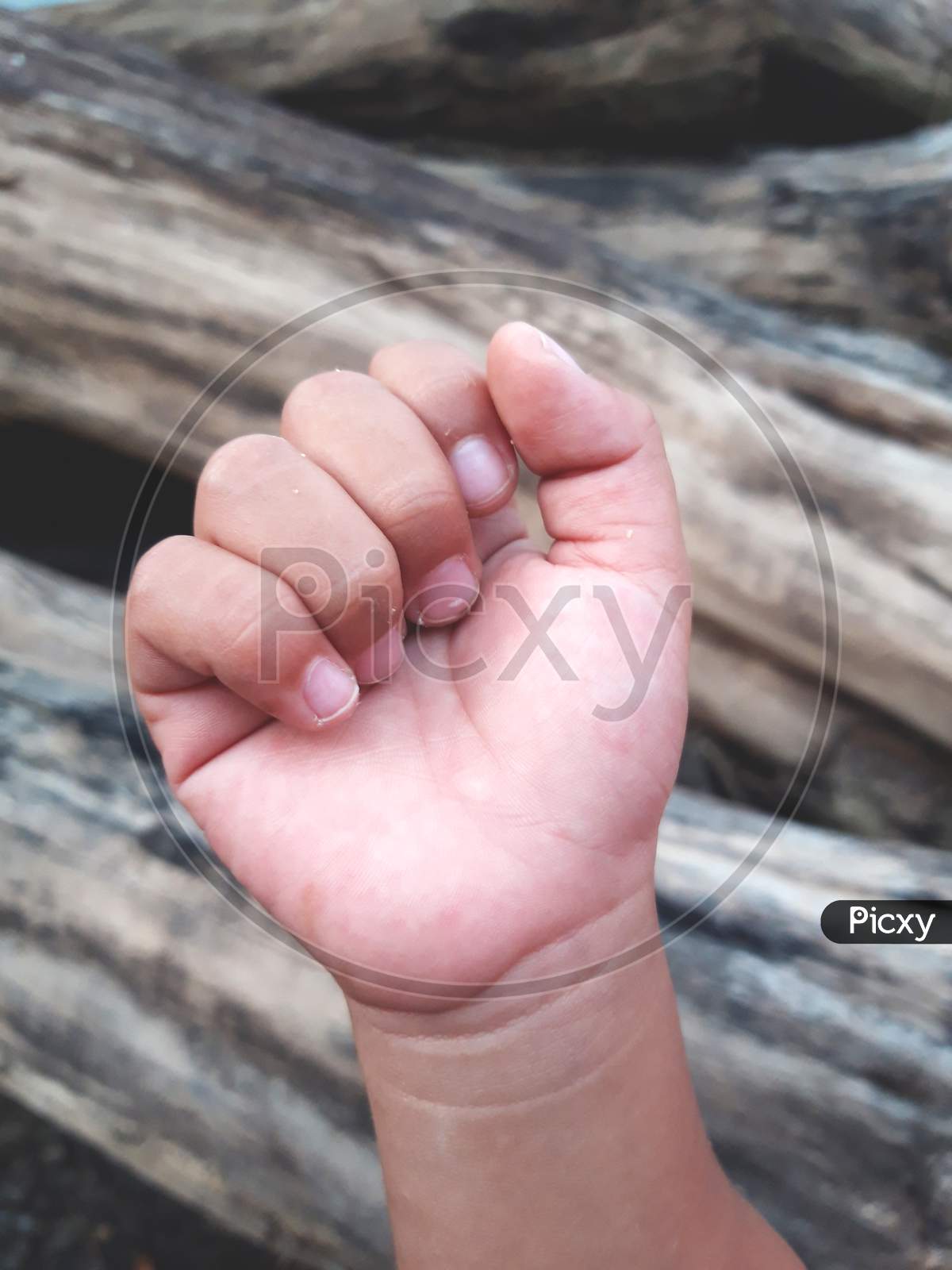 Close Up of Child Hand Clenched Into A Fist