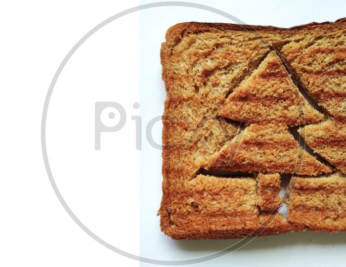 Concept of Christmas morning breakfast meal. Funny christmas tree toasted brown bread for kids.