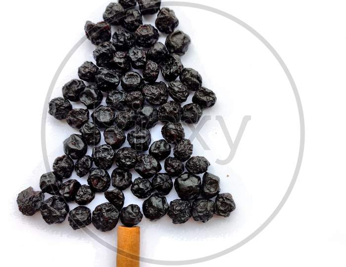 Christmas tree made of dried blueberries and cinnamon stick. Christmas holiday concept. Top view