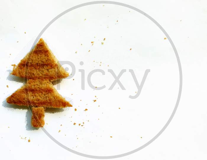 Concept of Christmas morning breakfast meal. Funny christmas tree toasted brown bread for kids.