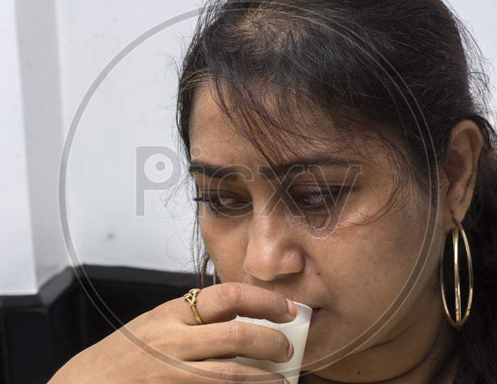 A Beautiful Indian Lady Drinking Indian Sarbat Or Refreshing Drink With Selective Focus