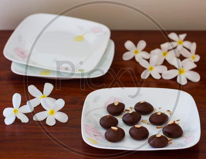 Selective focus on Dark Chocolate truffle or cocoa balls or pralines or candies,isolated on dark background,blur background.Also an Indian dessert called chocolate peda,pedha made during Dussehra.
