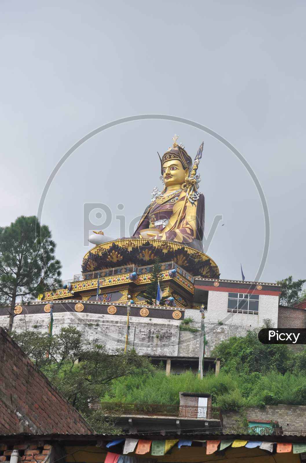 Low angle view of massive statue of Padmasambhava (Guru Rinpoche) in Rewalsar lake (Tso Pema), Himachal Pradesh, India