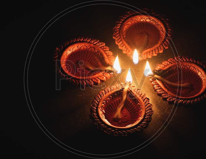 Clay diya lamps lit during Diwali Celebration