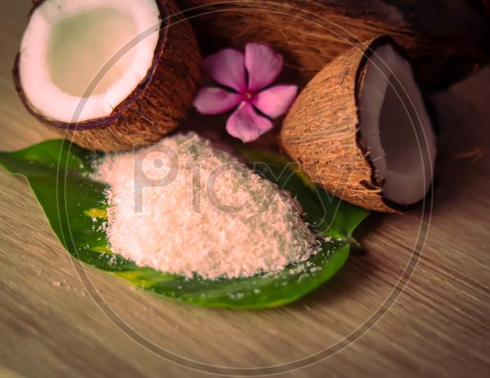Cracked Coconut And Grated Coconut Flakes On Wooden,Coconut And Coconut Milk In Glass On Wooden Table, Fresh And Healthy Coconut Milk And Half Coconut Fruit,Selective Focus On Subject,