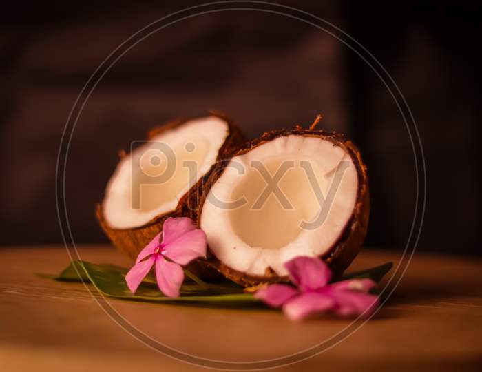 Grounded Coconut Flakes,Half Coconut With Green Leaves Wooden On Background,Hd Footage Of Coconut Milk And Half Coconut On Wooden