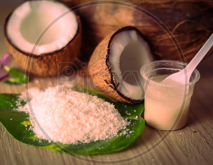 Half Coconut And Coconut Milk With Coconut Powder On Wooden Table, Coconut Powder On Green Leaf,Coconut Milk