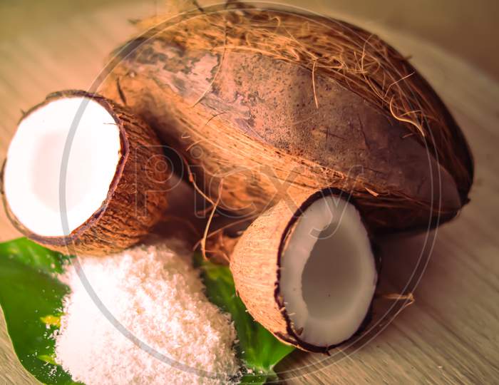 Half Coconut And Coconut Milk With Coconut Powder On Wooden Table, Coconut Powder On Green Leaf,Coconut Milk ,Selective Focus On Subject,