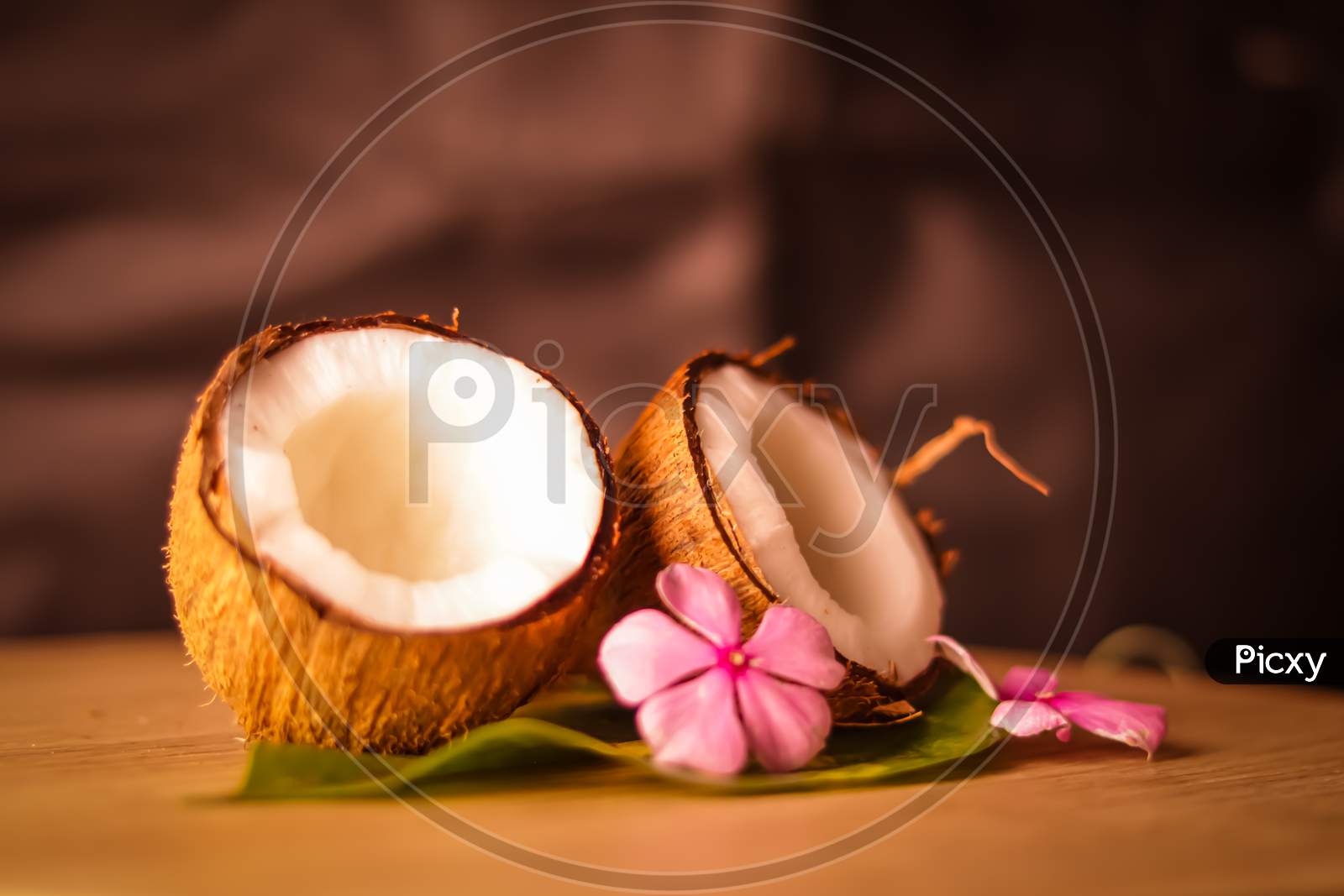 Coconut And Coconut Milk On Wooden Table,Coconut With Leaves And Flower,Glasses Of Coconut Milk,,Selective Focus On Subject,