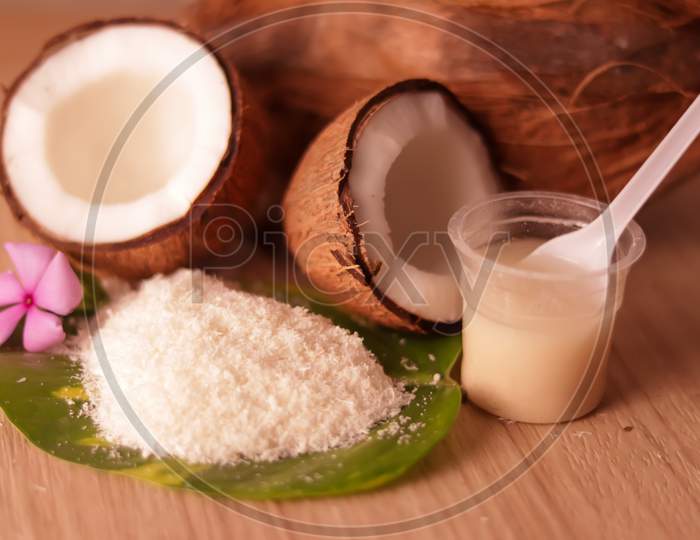 Cracked Coconut And Grated Coconut Flakes On Wooden,Coconut And Coconut Milk In Glass On Wooden Table, Fresh And Healthy Coconut Milk And Half Coconut Fruit