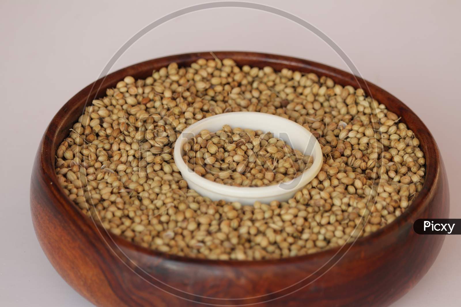 Coriander In Bowl On Wooden Background,Coriander Seeds In A Big Wooden Bowl,Healthy Eating,Indian Spice,Flavouring,Selective Focus,Dried Coriander Seed Bowl