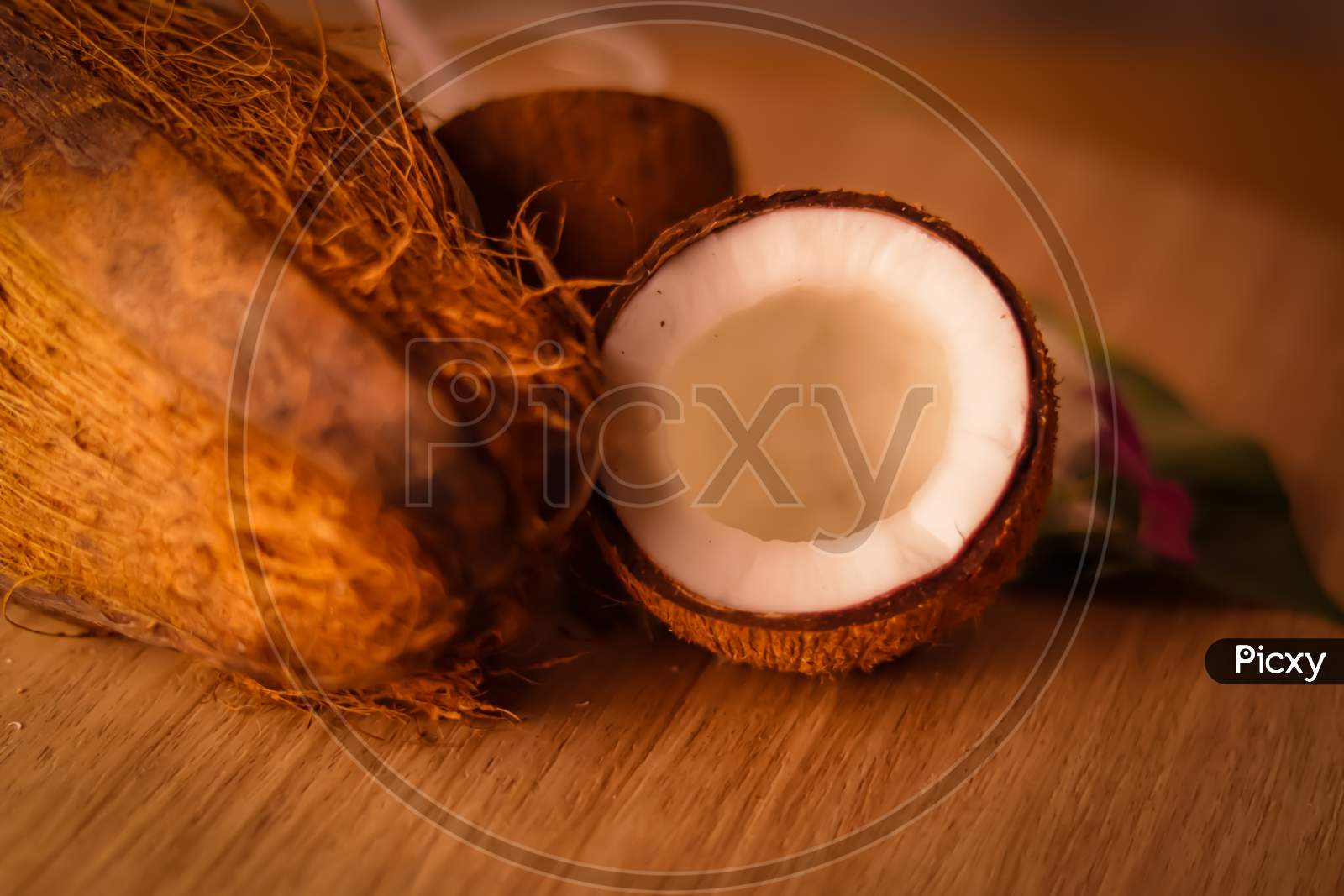 Coconut With Fresh Coco Milk And Powder On Wooden Table,Healthy Coconut Milk With Whole Nut,Coconut With Leaves And Flower,Cracked Coconut And Grated Coconut Flakes On Background.,Selective Focus On Subject,