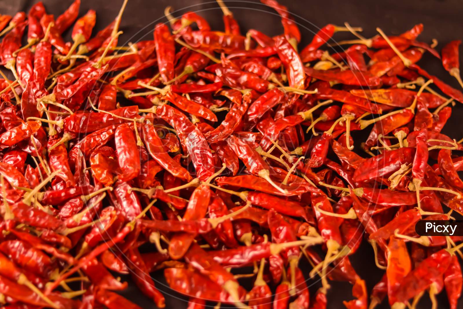 Dry Chilli Peppers,Spicy Seasoning,Lot Of Dried Chili As A Food Background,Dried Red Peppers On A Wooden Table,Red Dry Chili Pepper Background,Dry Paprika Hd Footage
