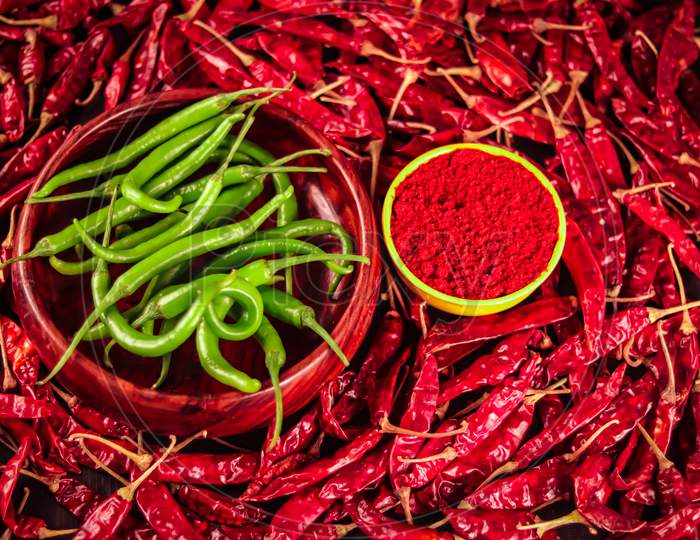 Green Chili And Red Chili Peppers On Table,Green Chillies Are Falling On Dry,The Green Chillies Are Falling Into The Agriculture Background,