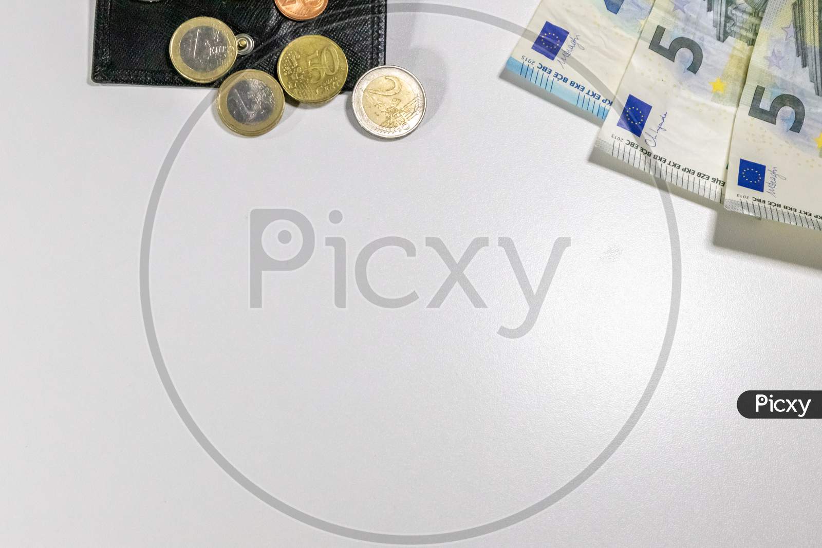 European money with black wallet on white desk as white background with different euro coins and euro bank notes poverty investment financial management and income business plans need for housekeeping