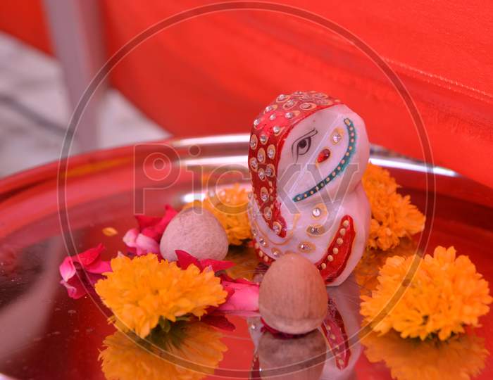 Lord Ganesha photograph at Ganesh puja with decorative thali