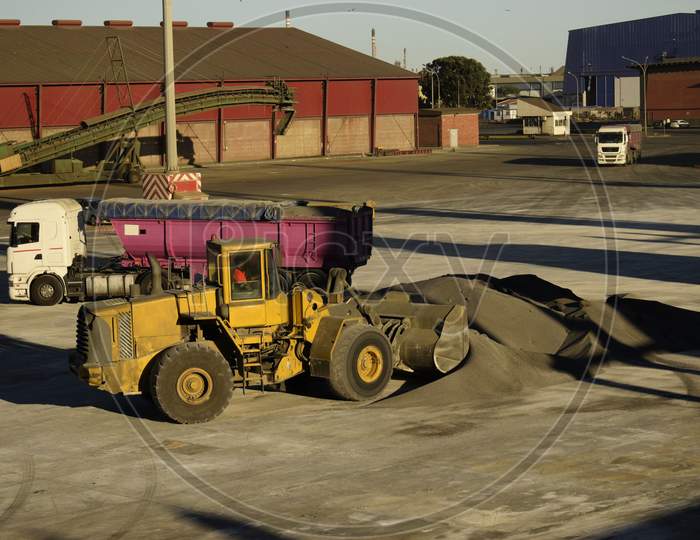 bulldozer or payloader preparing cargo inside port