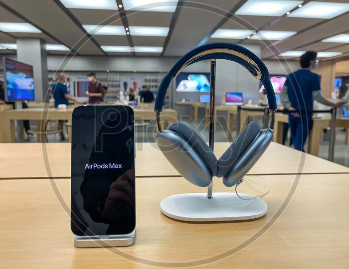 Cologne, Germany - October 01st 2021: A german photographer comparing and testing the new Airpod Max in different colors in an Apple Store.