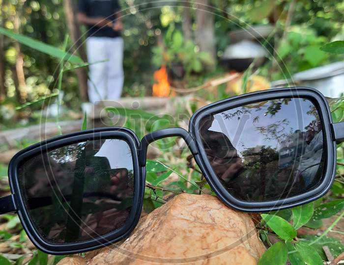 Sunglasses close up in a jungle background