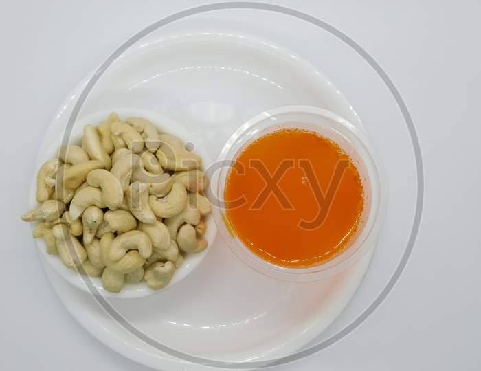 Cashew / Kaju And Soft Drink In White Plate With Isolated White Background