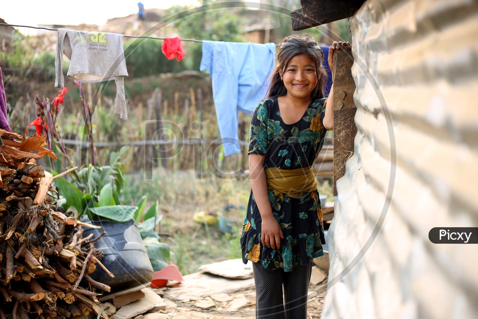 A shy, rural girl smiling and looking into the camera. Rural life photo.
