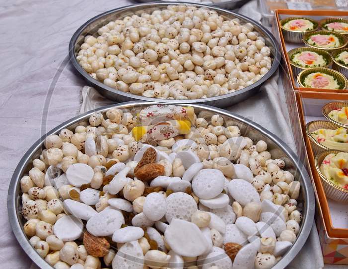 Dry fruits and sweets in an Indian traditional plate