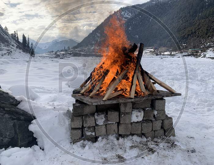 Bonfire in snow ; winters