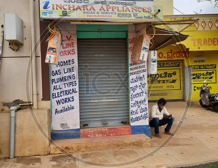 Closeup Of Shutter Closed Small Indian Home Appliances Shop On Roadside.