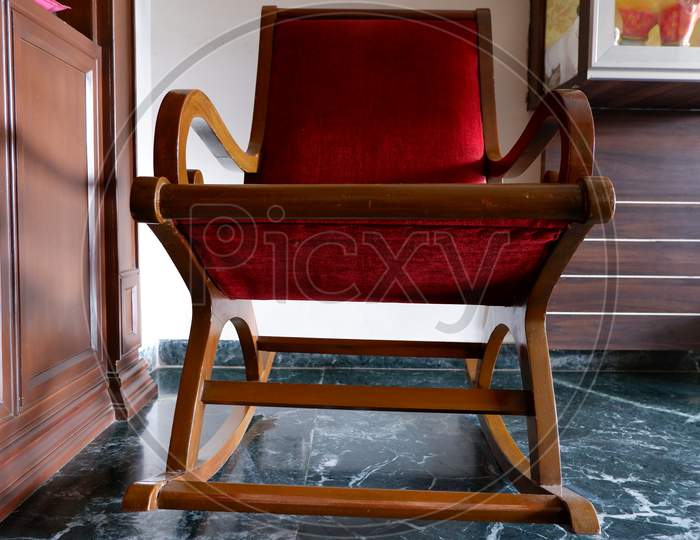 Red wooden rocking chair for the rest
