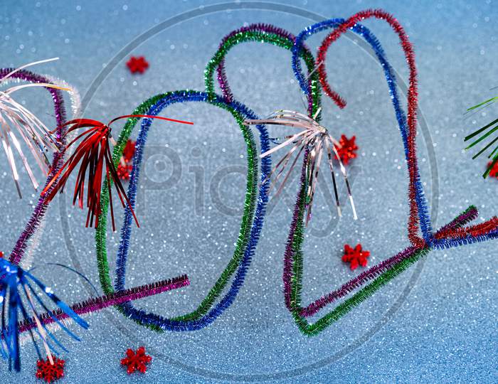 2022 New Years Postcard With Festive Multicolored Pipe Cleaners.