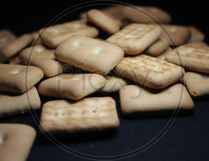 Many Rectangular Biscuits With Small Pores On Black Floor