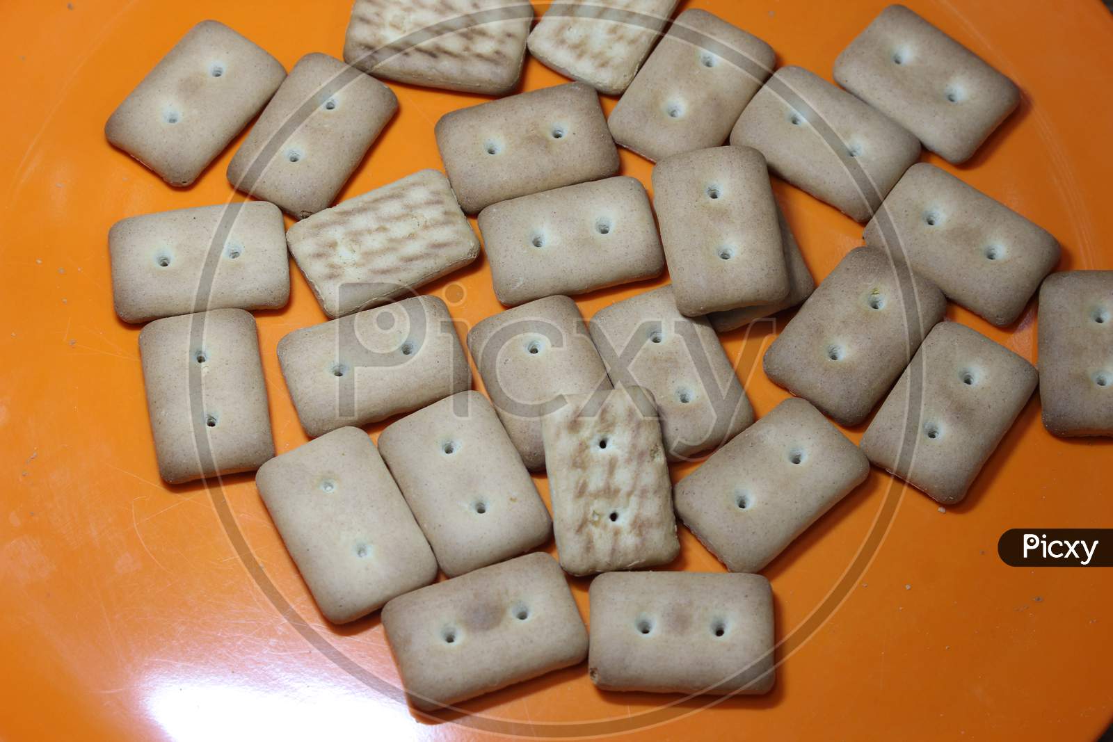Many Rectangular Biscuits With Small Pores In Red Plate