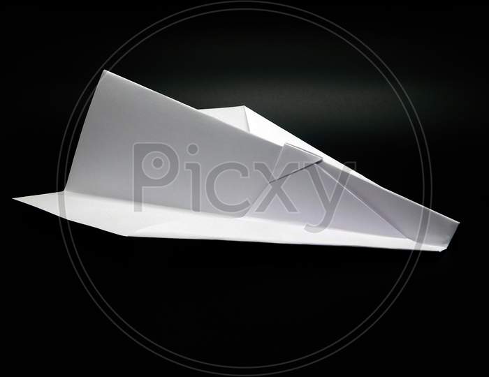 White Paper Made Airplane On Black Background