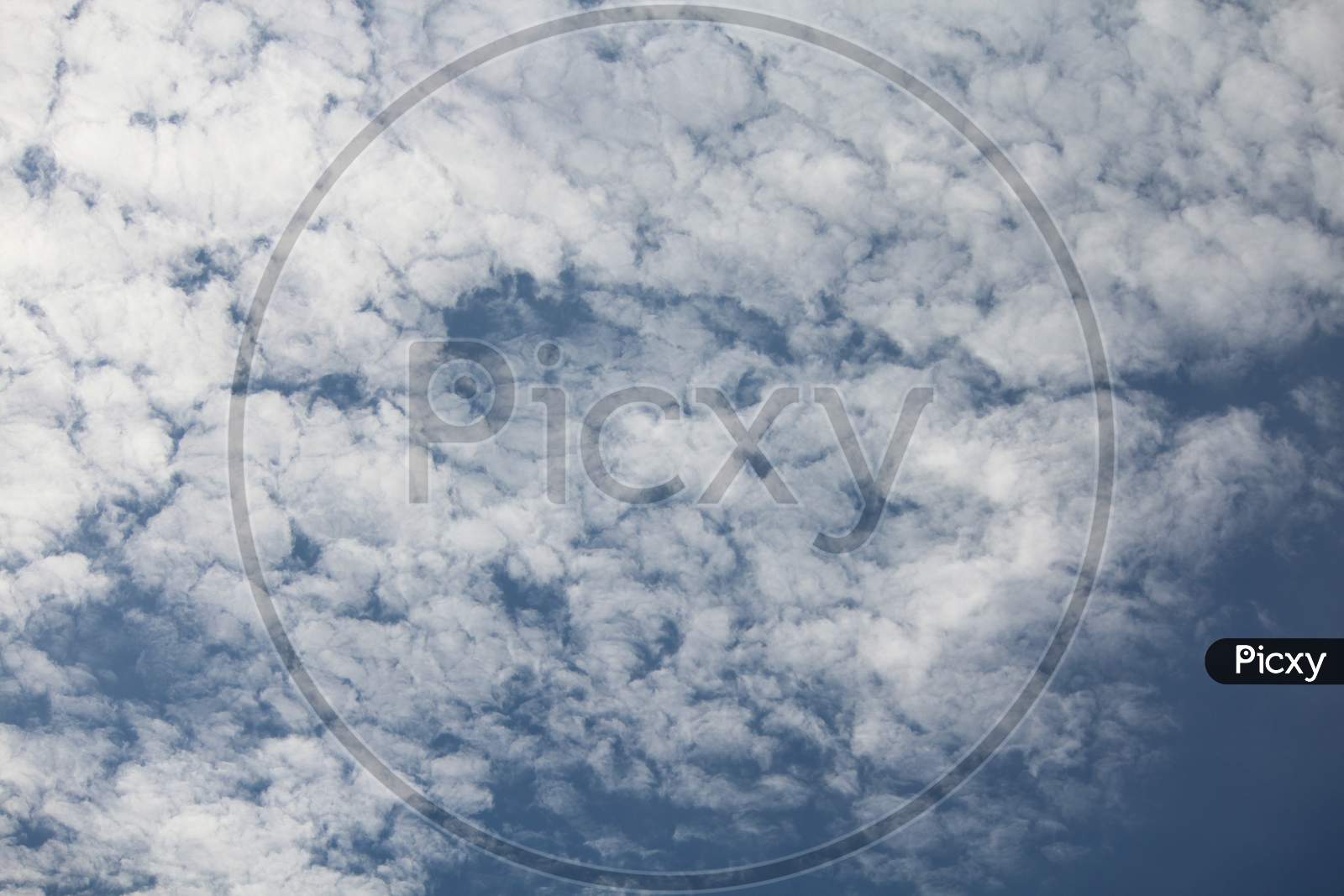 White Fluffy Clouds On Blue Sky In Summer