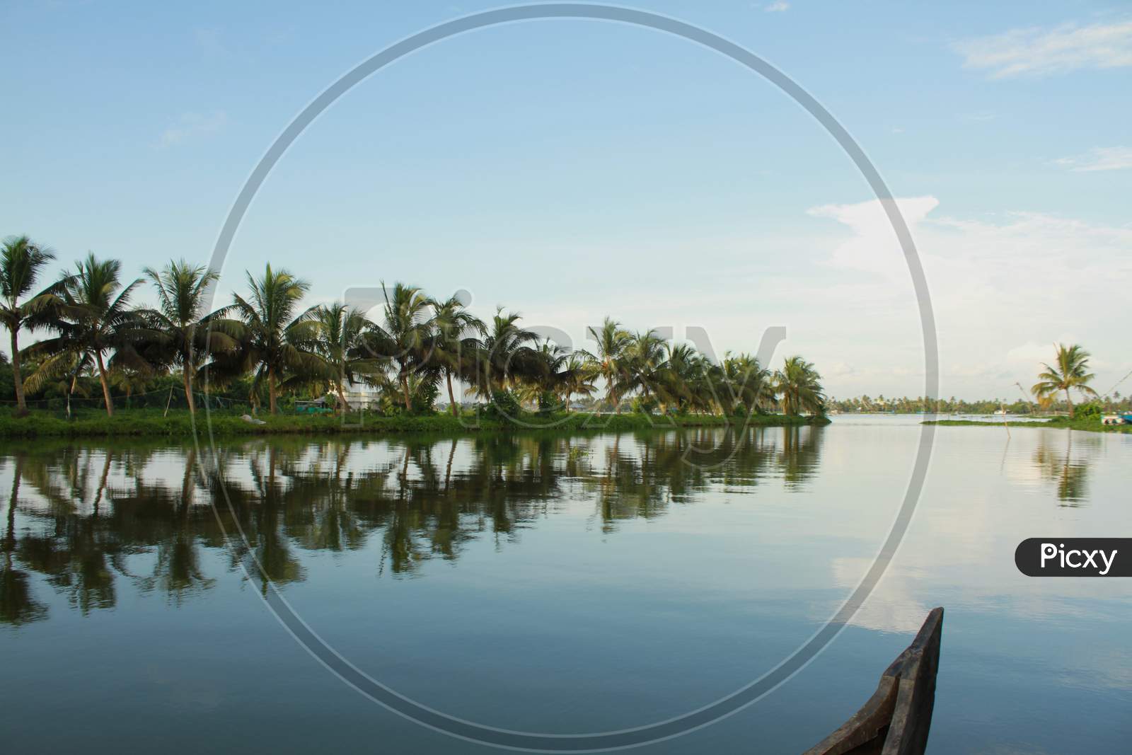 Lake Banks With A Partial View Of The Fishing Boat And Coconut Trees