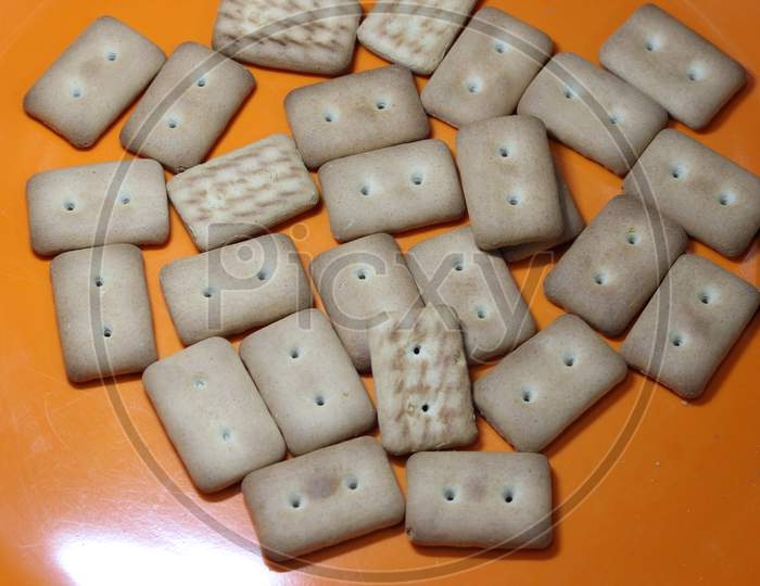 Many Rectangular Biscuits With Small Pores In Red Plate