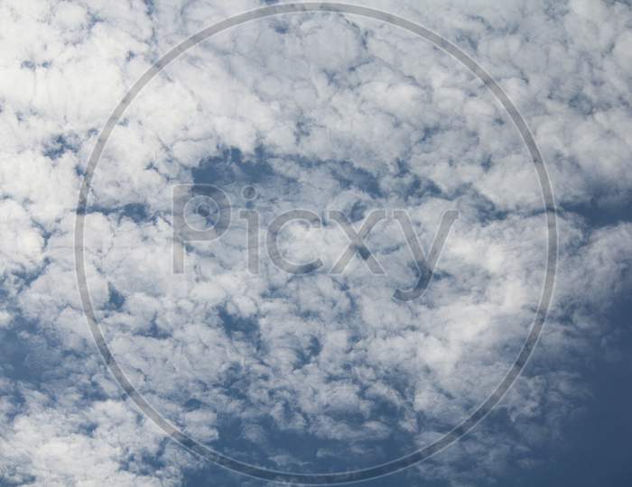 White Fluffy Clouds On Blue Sky In Summer
