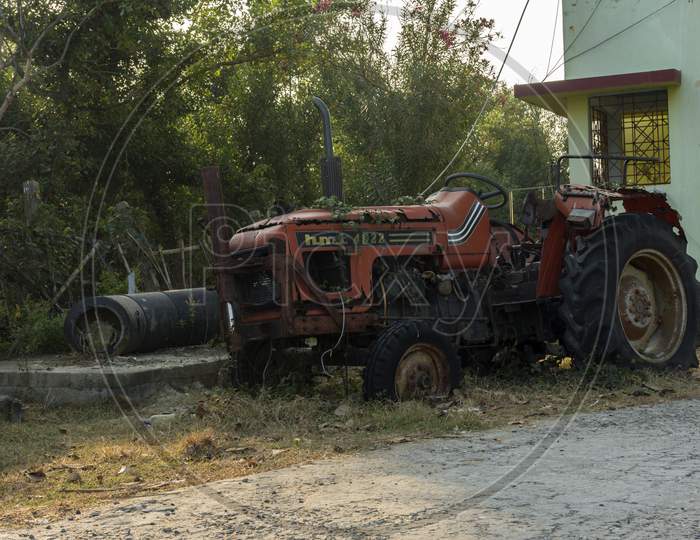 8Th January, 2021, Henry Island, West Bengal, India: An Old Rusty Broken Red Tractor Standing Roadside.