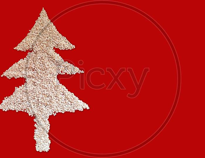 White Sesame Seed Christmas Tree Designed On Red Background With Blank Space. Top View. Christmas