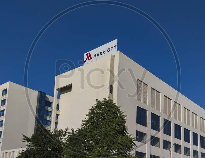 Jaipur, Rajasthan, India- October 22, 2021: Building Sign On Marriott Hotel , Blue Letters On A Glass Tower.