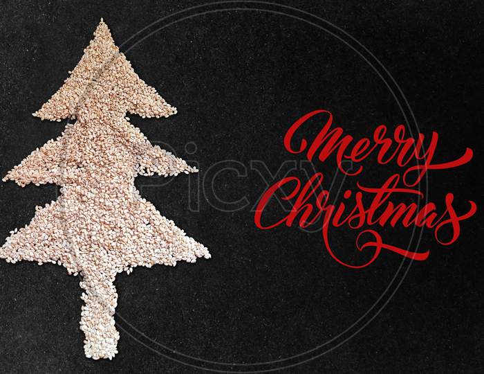 White Sesame Seed Christmas Tree Designed On Black Granite Texture Background Top View