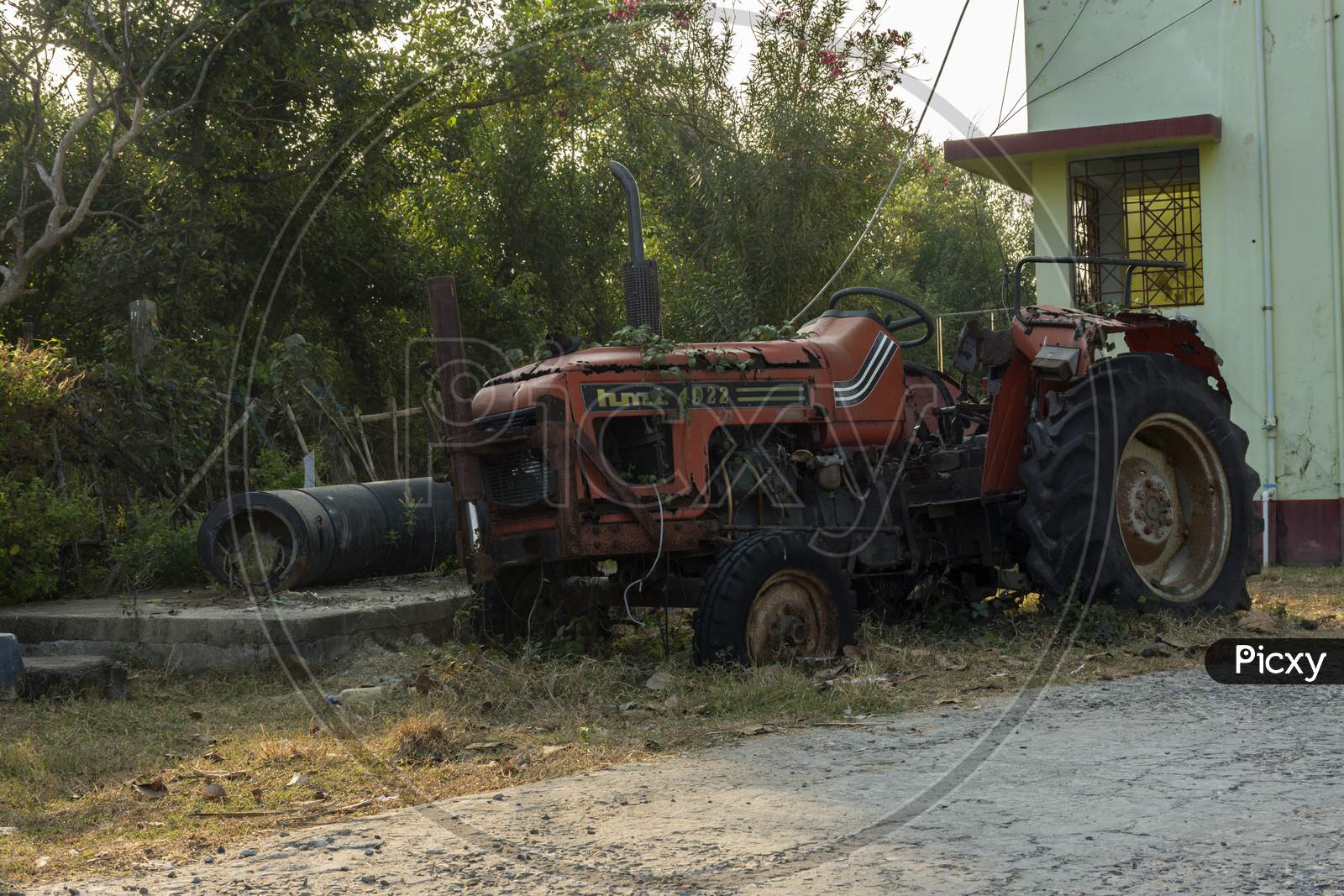 8Th January, 2021, Henry Island, West Bengal, India: An Old Rusty Broken Red Tractor Standing Roadside.