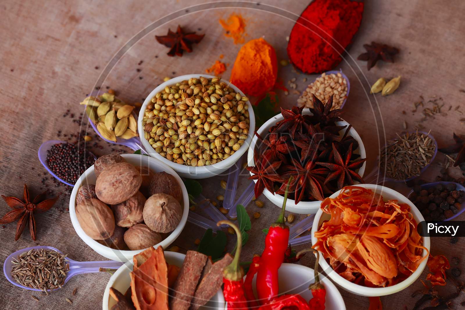 Colorful Herbs And Spices For Cooking,Indian Spices,Indian Spices On Wooden Table,Indian Cuisine. Top View Flat Lay,Indian Bay Leaf, Garam Masala, Mace, Javitri, Nutmeg, Jaiphal, Star Anise,