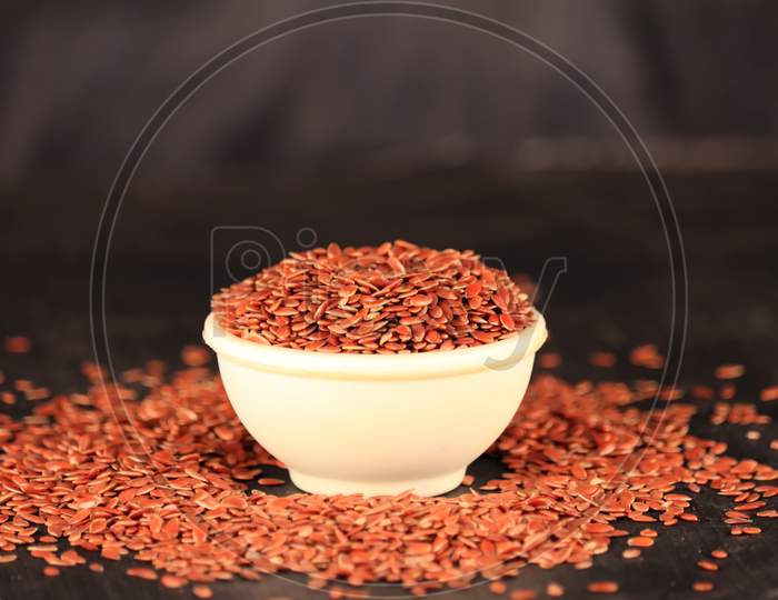 Flex Seeds In A White Bowl With The Black Background,High Fibre Flex Seed In Bowl,Linum Usitatissimum,Also Known As Linseed