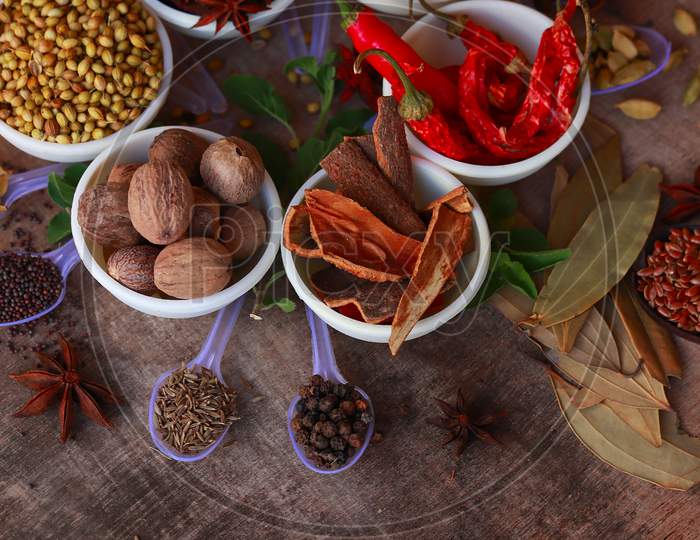 Colourful Various Herbs And Spices For Cooking,Cumin, Black Pepper, Cloves, Cardamom, Fennel, Bay Leaf,Garam Masala, Mace, Javitri,Background Rotating,